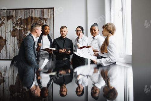 Preview: High angle view of successful young business people using gadgets