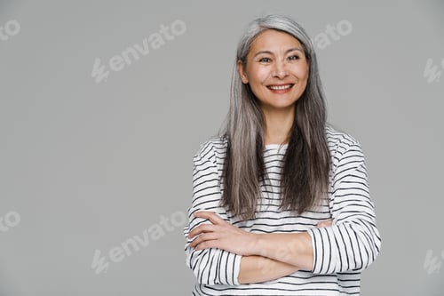 Preview: Mature white-haired woman smiling and looking at camera
