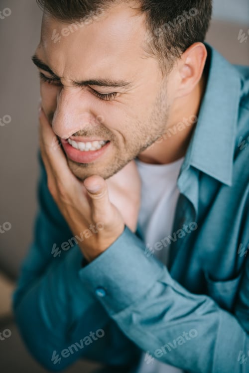 Preview: close-up view of young man suffering from toothache
