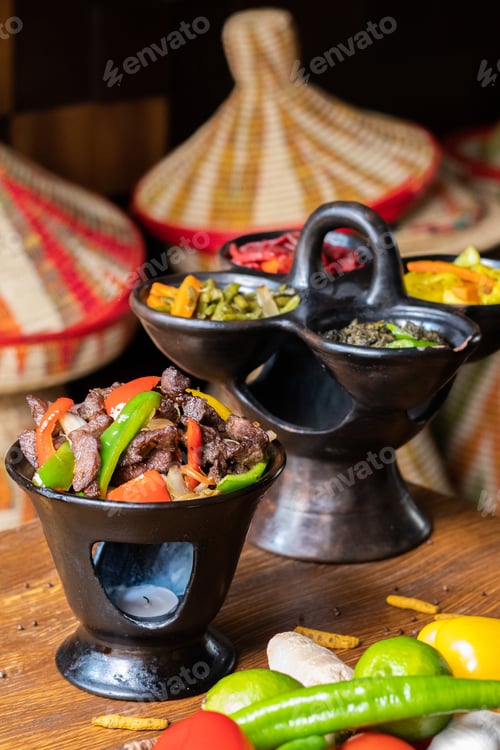 Preview: Vertical shot of delicious Ethiopian food with fresh vegetables on a wooden table