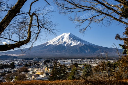 Preview: view of Mount Fuji with snowy peak and a clear blue sky overlooking Fujikawaguchiko in Japan