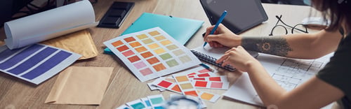 Preview: Close up shot of working process of interior designer making notes in her notebook, selecting