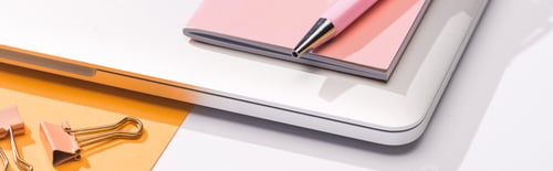 Preview: panoramic shot of laptop, paper, notebook, pen and paper clips