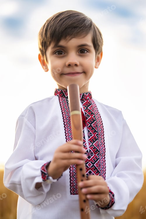 Preview: Portrait of little boy child with woodwind wooden flute - ukrainian sopilka, tylynka on sky