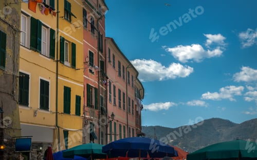 Preview: fragment of buildings with warm colors of facades and umbrellas, Italian seaside Vernazza, Italy