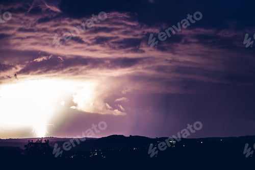 Preview: Night landscape on a background of thunderstorms. Rural silhouette and clouds with lightning flashes