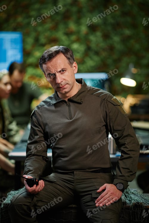 Preview: Strict mature male officer of surveillance department with walkie-talkie