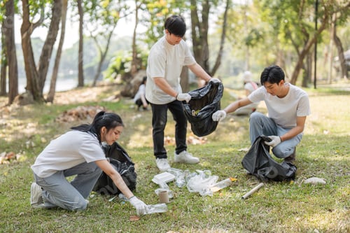 Preview: Volunteers sorting and collecting waste during a community cleanup event in the park.