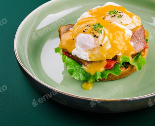 Preview: Tasty egg Benedict on green plate