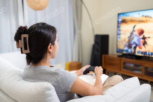 Preview: Woman play video game at home