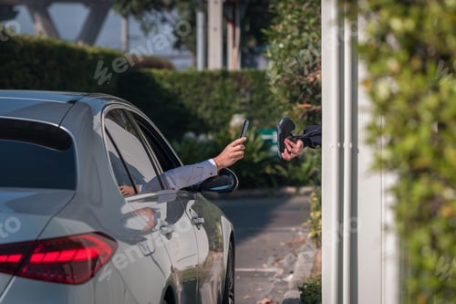 Preview: Human Hand pay for food or drinks with your mobile phone at the Drive Thru counter.