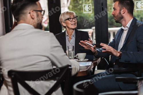 Preview: Group of business people having a meeting at office cafeteria.