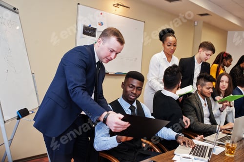 Preview: Multiracial young creative people in modern office