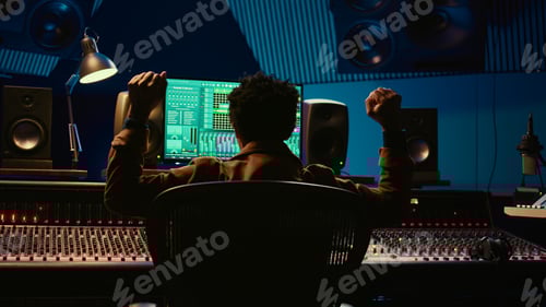 Preview: African american music producer vibing on his new track in professional studio