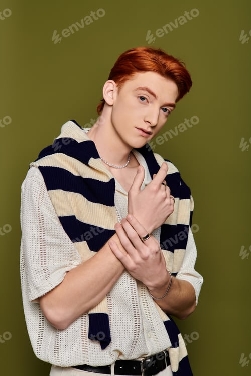 Preview: Young handsome man expressing deep emotions in a vibrant studio setting during a photoshoot