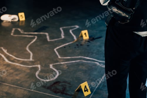 Preview: cropped view of investigator standing near chalk outline and evidence markers at crime scene