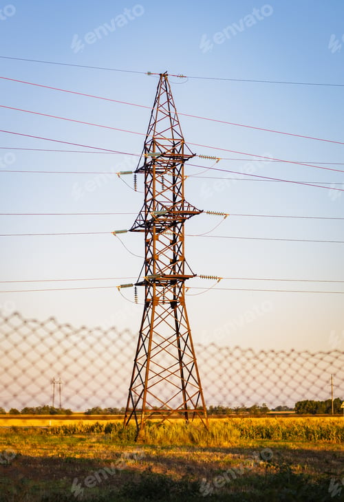 Preview: High voltage pole with wires on the field.