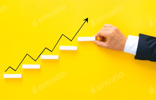 Preview: Businessman hand arranging wood block stacking as step stair with growth arrow. Business growth suc