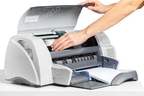 Preview: Printer being loaded with paper and supplies at a work desk setting during daylight hours