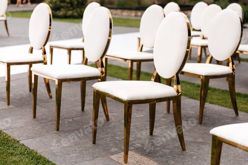 Preview: Luxury white-golden chairs on wedding ceremony outdoors. Festive decorations. Empty rows armchai