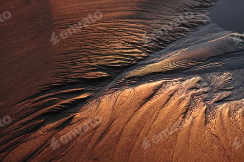 Preview: High angle close up of patterns in beach sand at dusk.