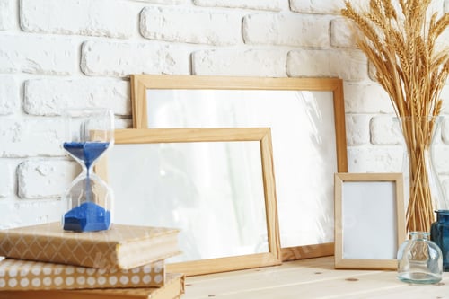 Preview: Photo frames on a brick wall background on the table with wheat ears in vase