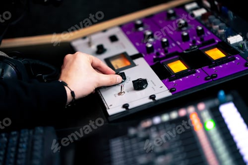 Preview: close up hands in the recording room dark with neon lighting in the studio, the sound engineer works
