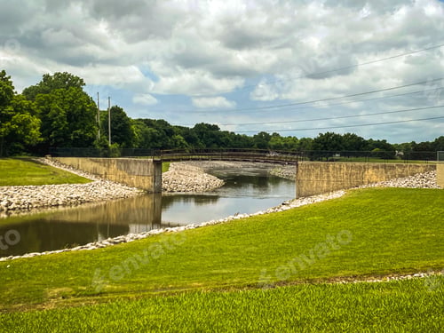 Preview: Bridge over a creek and green trees in the background
