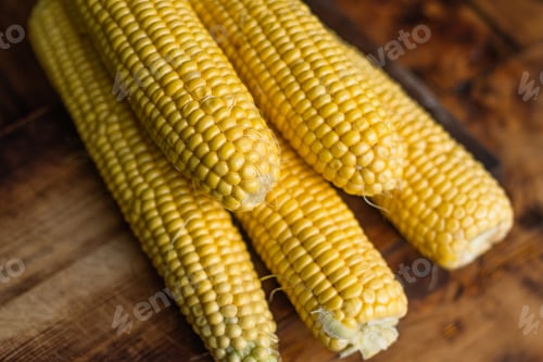 Preview: Ripe yellow corn cobs on rustic background.