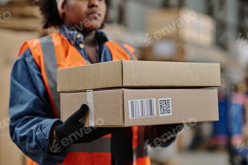 Preview: Worker carrying box in warehouse