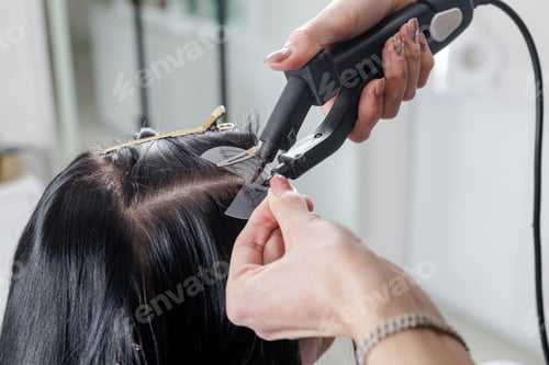 Preview: Hair extensions keratin fusion installation with heat bonding tool in salon