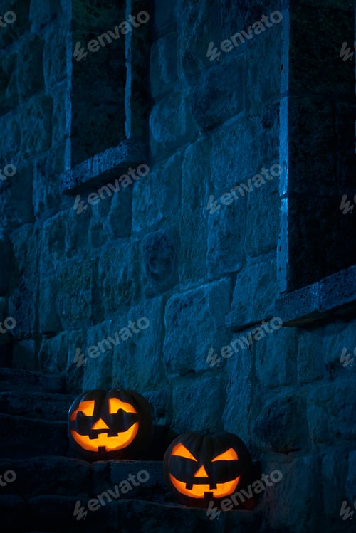 Preview: Halloween pumpkins jack p lantern in the yard of an old castle at night in the bright moonlight