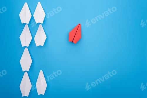 Preview: Flat lay with white and red paper planes on blue