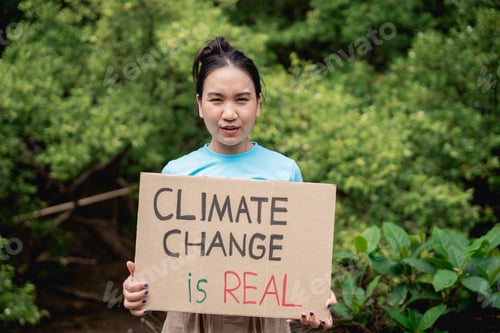 Preview: Volunteers protest and hold a sign to make everyone save the world in the forest park area.
