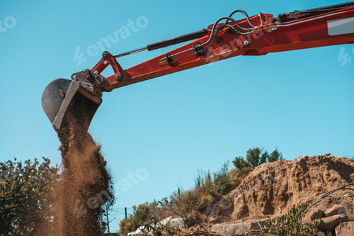 Preview: Closeup of a backhoe with dirt against sky