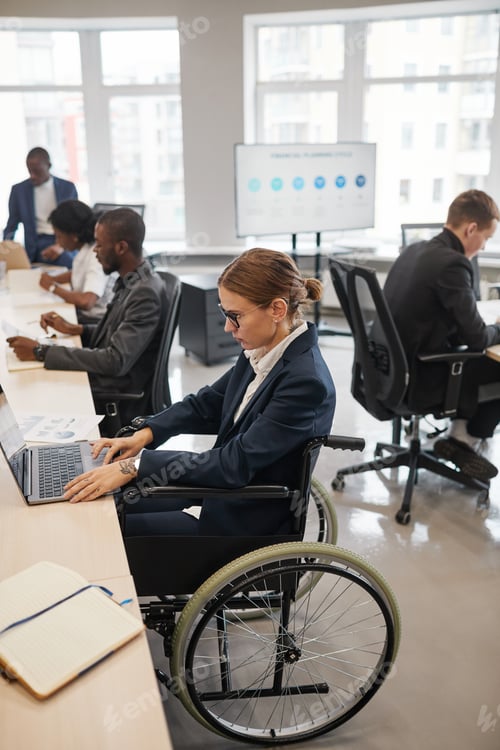 Preview: Woman in Wheelchair Working in Office Vertical
