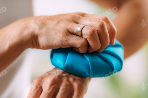 Preview: Wrist Pain Treatment. Woman Holding Ice Bag Compress on a Painful Wrist.