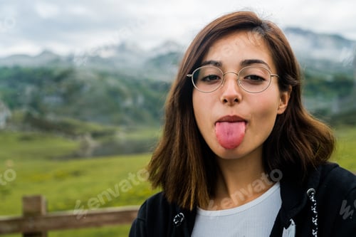 Preview: Woman sticking tongue out to camera