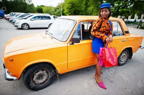 Preview: African american lady near orange classic retro car