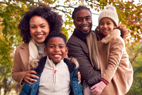 Preview: Portrait Of Smiling Family On Walk Through Countryside Against Autumn Trees