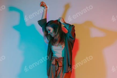 Preview: Woman dancing freely in vibrant colorful light