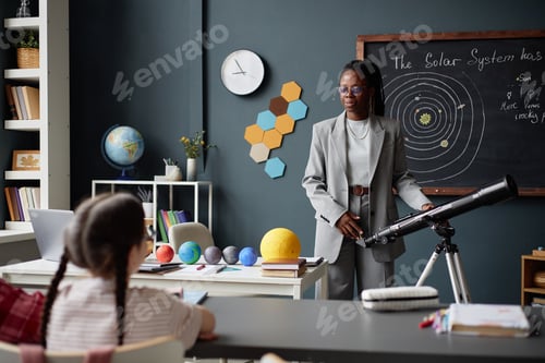 Preview: Black Woman Teaching Astronomy to Children in Classroom