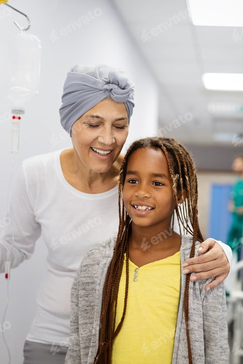 Preview: Sick woman with cancer hugging her young grandchild in hospital. Family support concept