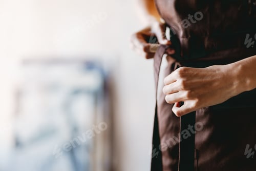 Preview: Black student woman wearing apron during class in art school