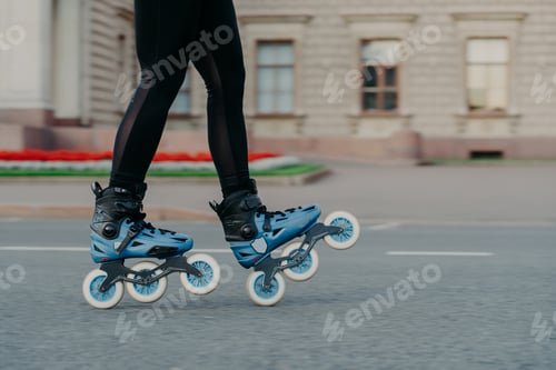 Preview: woman in blue rollerskates moves on road spends free time actively tries new exercise