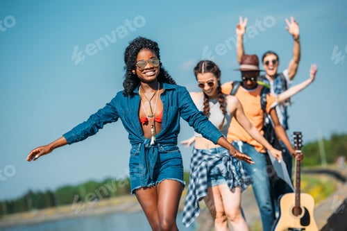 Preview: multiethnic happy young friends in casual clothing looking at camera