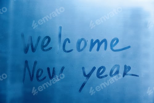 Preview: lettering Welcome New year on foggy glass of blue window