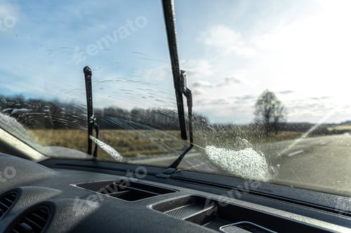Preview: Car wipers clean windshields when driving in sunny weather.