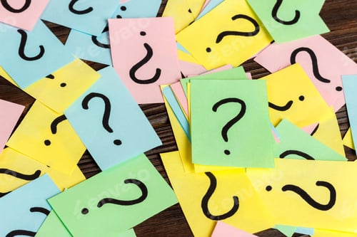 Preview: Pile of colorful paper notes with question marks on wooden background. Closeup