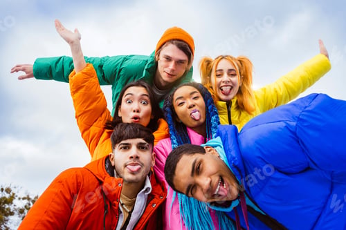 Preview: Multiracial group of young friends meeting outdoors in winter